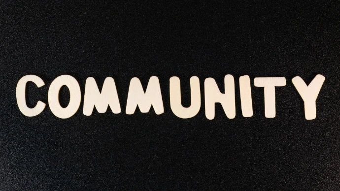 the word community written in white on a black background
